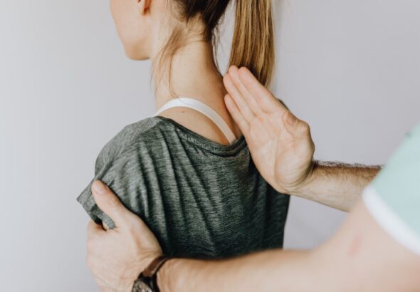 Image1a nurse is performing a physical examination of the spine